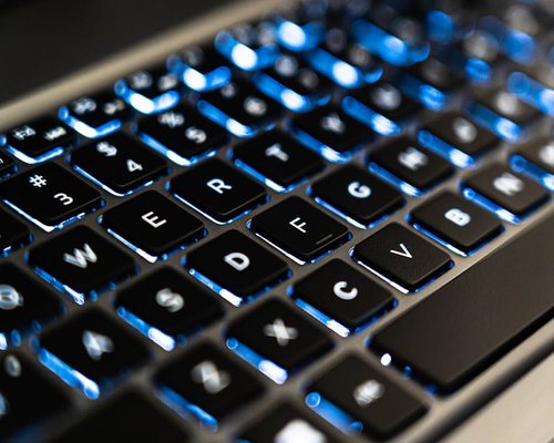 Detailed shot of someone typing on a laptop